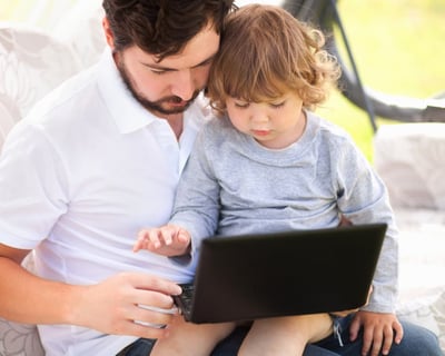 dad and son on laptop