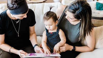 mom, dad, and daughter playing