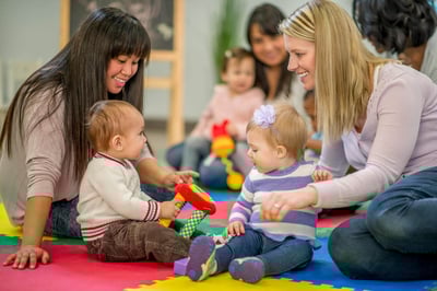 two moms playing with kids